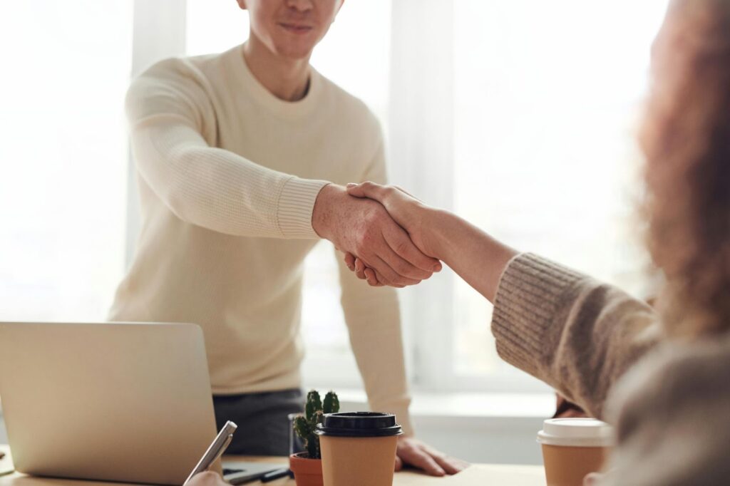 Two humans having a handshake symbolizing agreement.