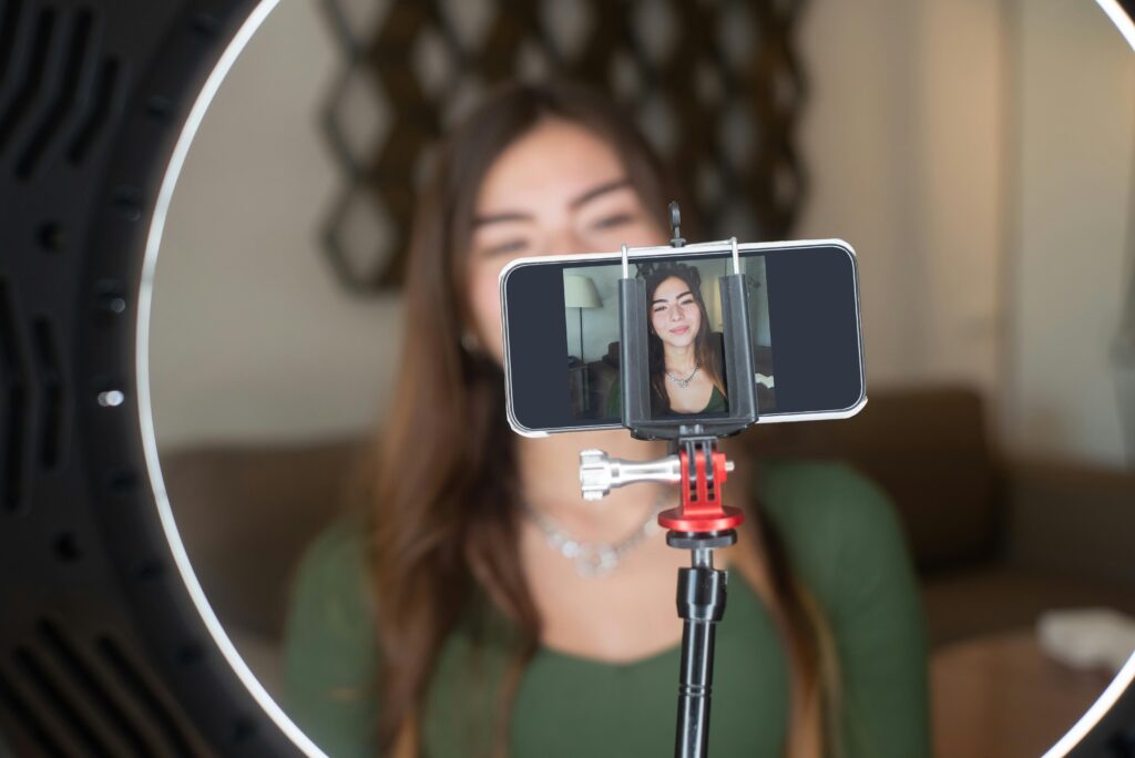 Girl filming herself with a phone.