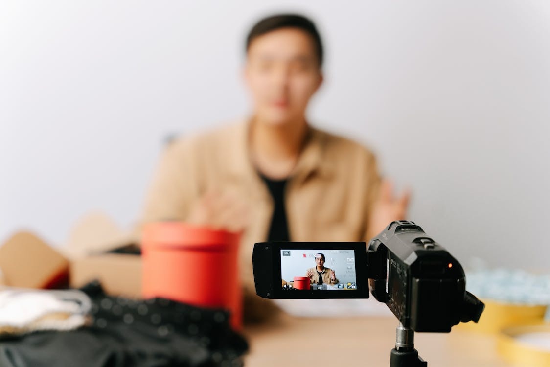 Creator filming a product video with a camera for social media content creation