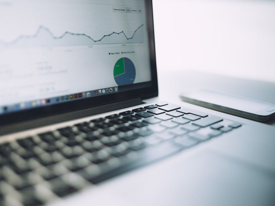 A laptop showing an analytics dashboard with charts and graphs, symbolizing modern data analysis tools.