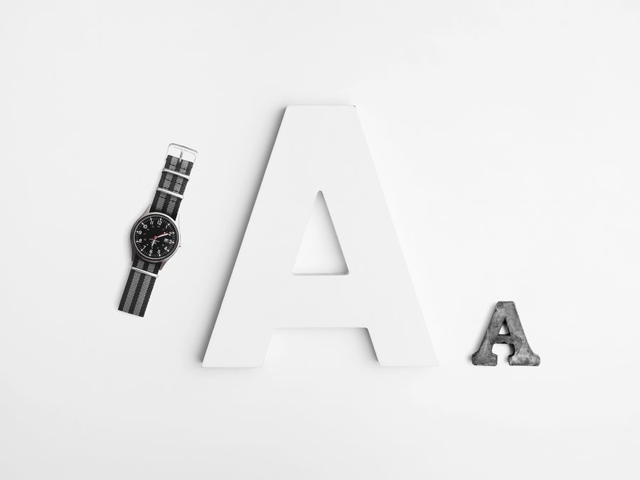 Minimalist layout featuring typography with a sleek watch and bold letter A design.