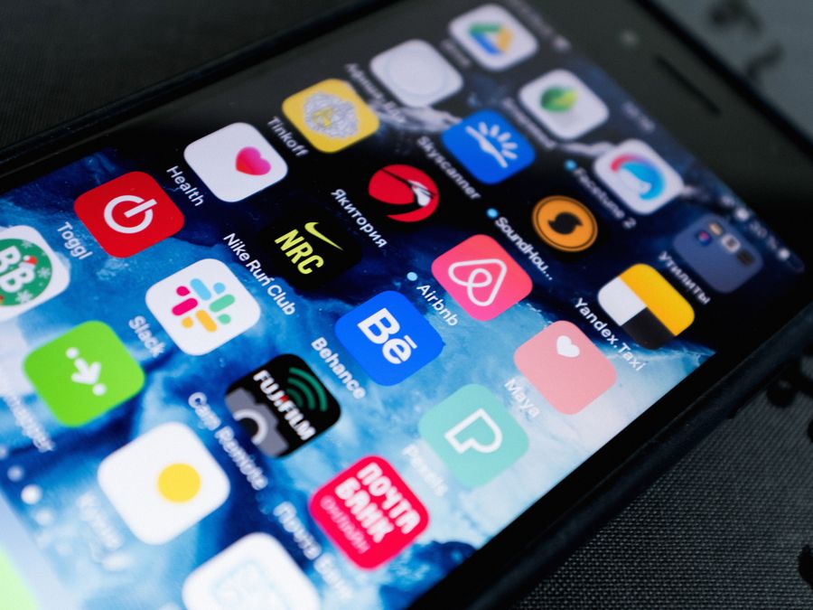Detailed view of smartphone displaying multiple app icons on screen, highlighting technology use.