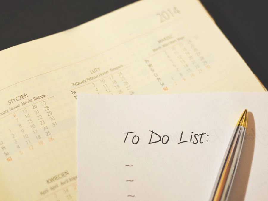 Close-up of a calendar and to-do list on a desk, emphasizing planning and organization.