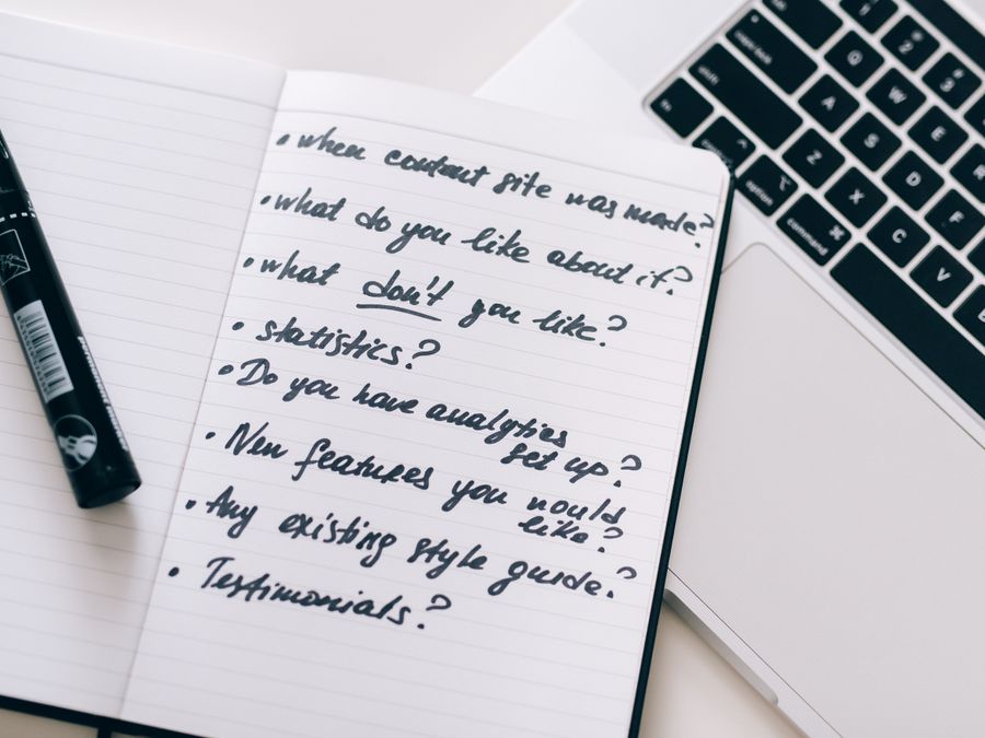 Close-up of a notebook with handwritten notes next to a laptop, ideal for business or educational content.