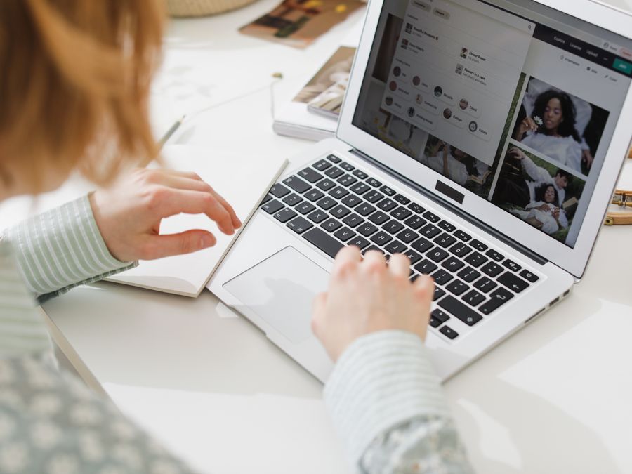 A person working remotely on a laptop in a modern, creative home office environment.