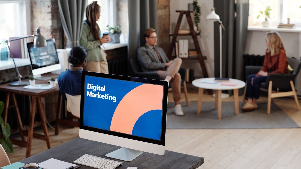 Collaborative team meeting in a modern office setting with digital marketing focus.