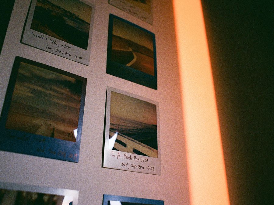 A vibrant wall displaying instant film photos with nostalgic and vintage tones.