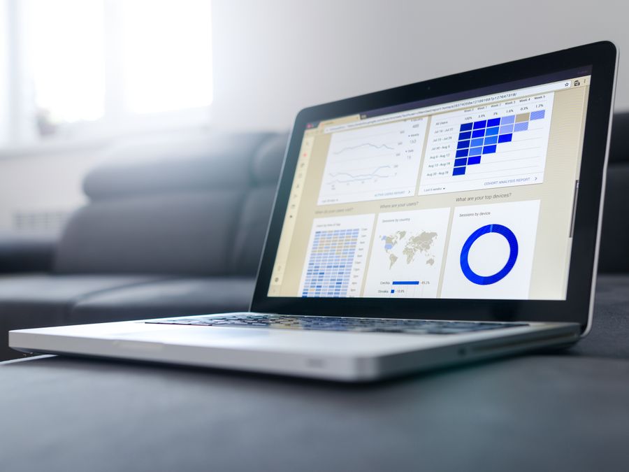 Sleek laptop showcasing data analytics and graphs on the screen in a bright room.