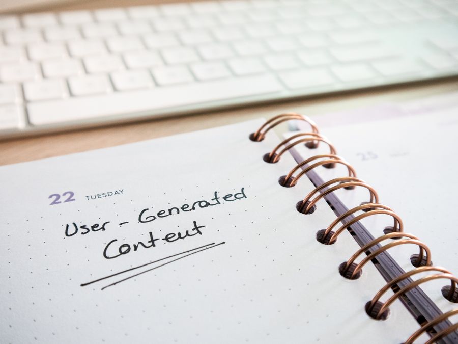 Notebook with user-generated content note and keyboard, ideal for planning and productivity.
