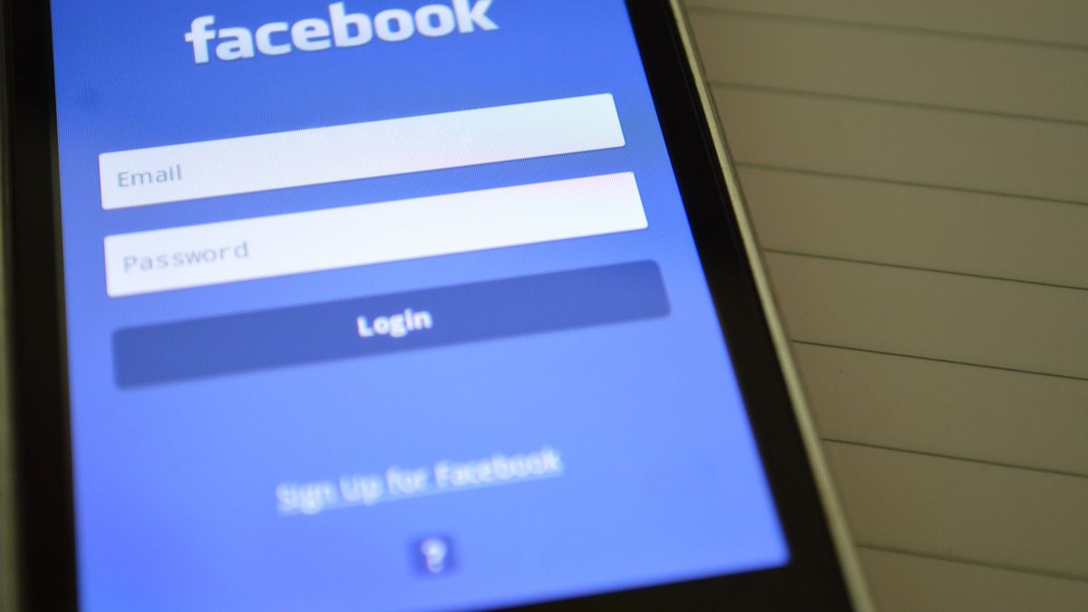 Mobile phone with Facebook login screen, highlighting digital connectivity and social media use.