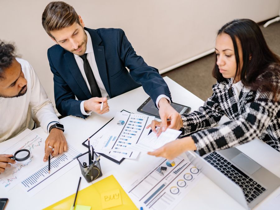 Business professionals engaging in a collaborative meeting with charts and documents.