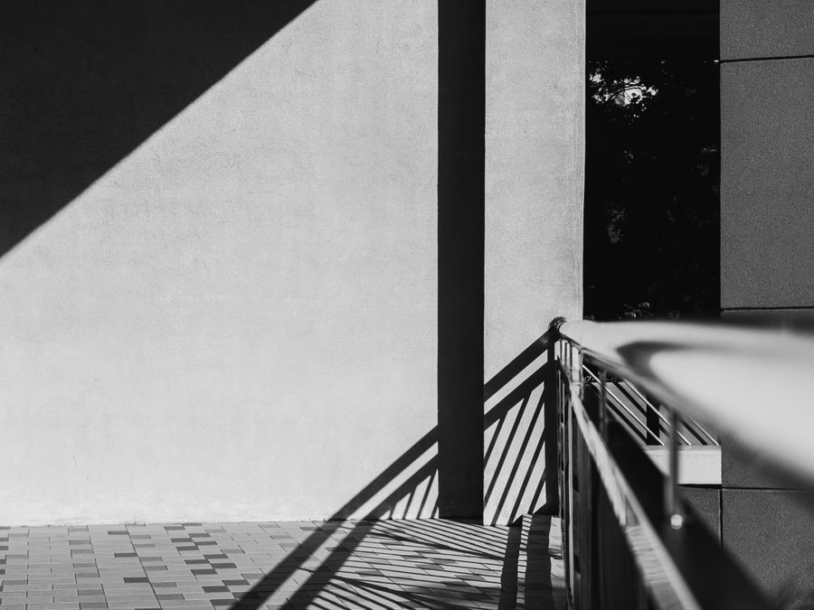 Minimalist black and white photo capturing architectural shadow play and geometric forms.