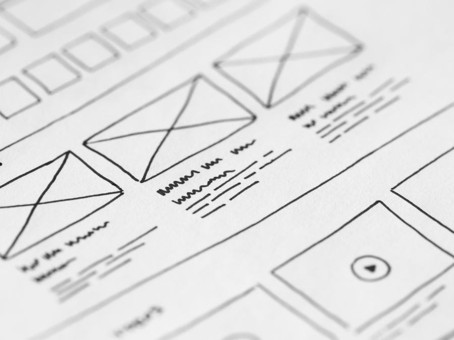 Detailed close-up of a hand-drawn wireframe design on paper for a UX project.