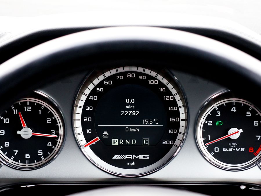 Detailed close-up of a vehicle dashboard featuring modern speedometers and controls.