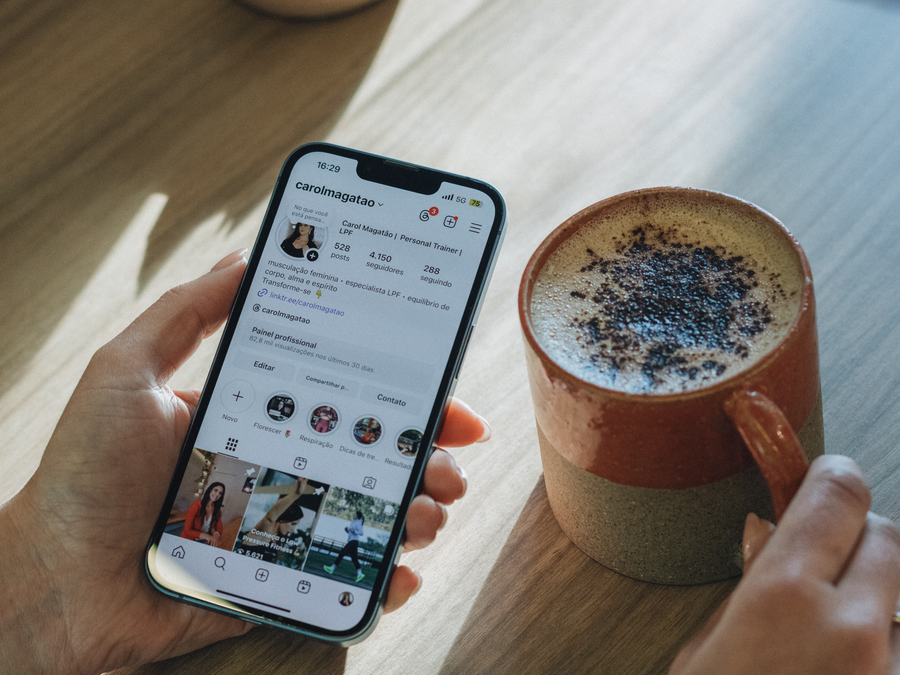 Person browsing Instagram over coffee, relaxed morning vibe.