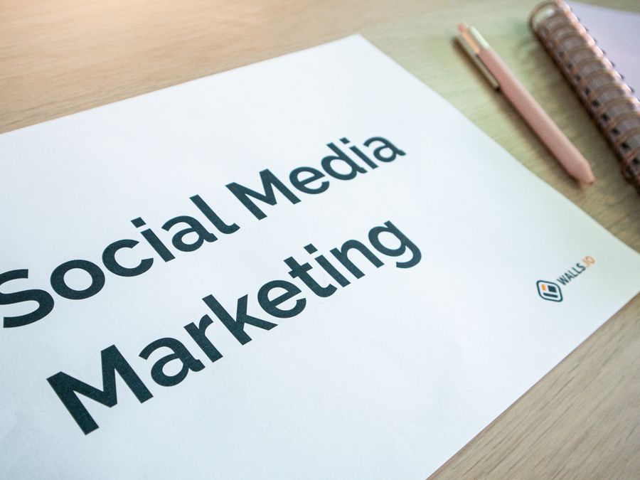 Close-up of a social media marketing document on a desk with a pen and notebook.