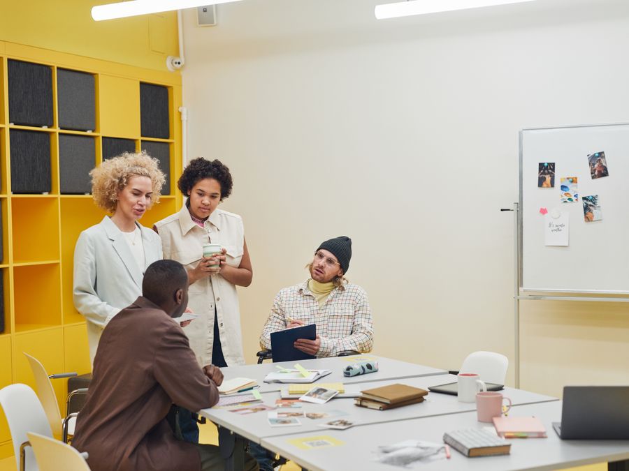 A diverse group of professionals having a collaborative meeting in a modern office space.