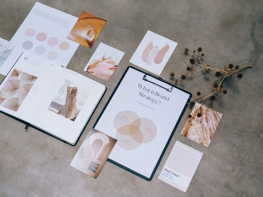Flat lay of branding strategy materials with moodboard and color palette for creative design.