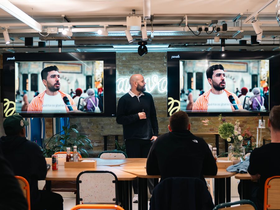 A professional leads a presentation with digital displays in a modern office environment.